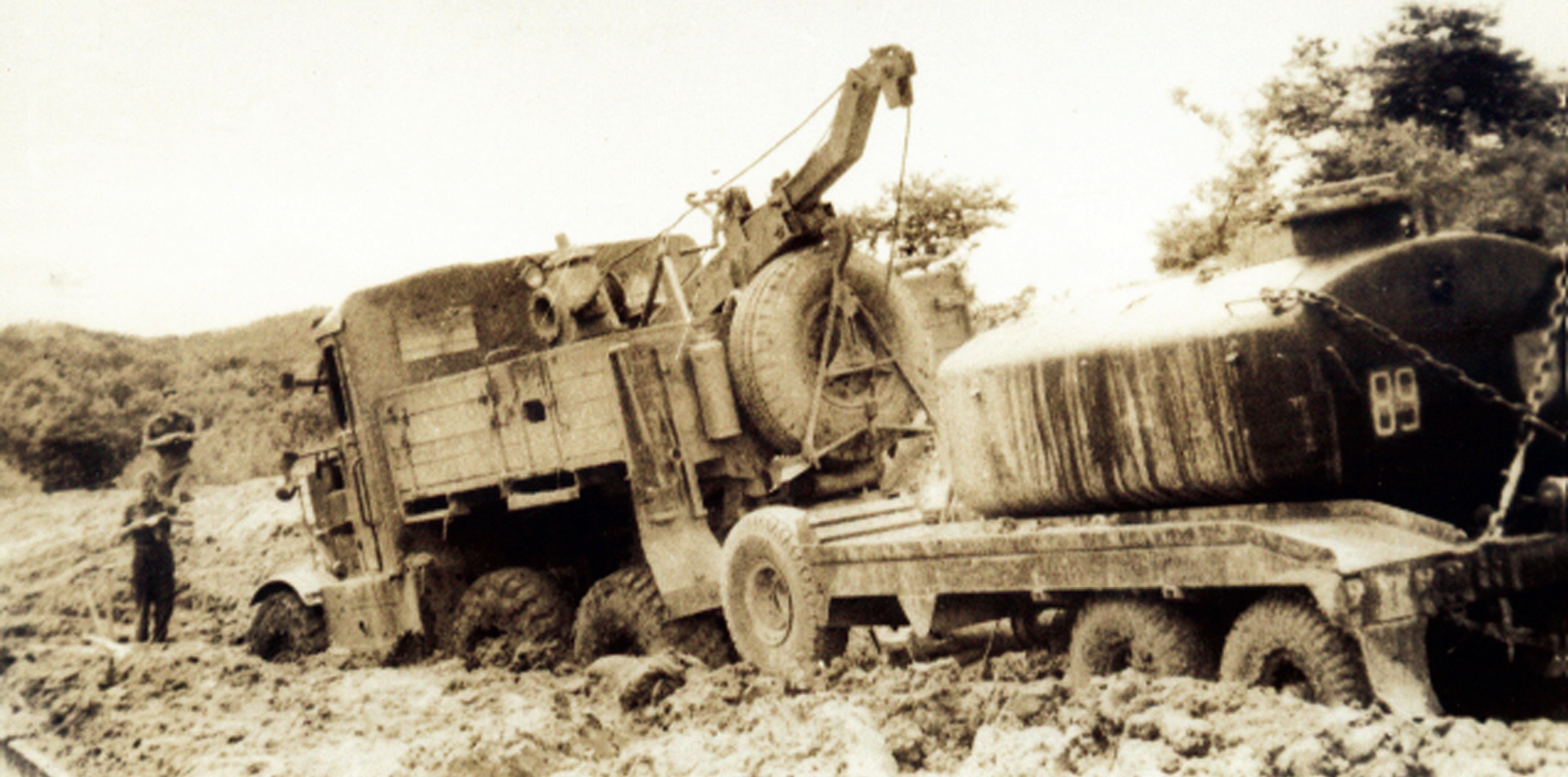 The monsoon turned roads to seas of mud. Here a Scammel and a trailer with water tank are badly bogged